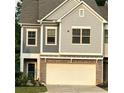 Charming two-story townhouse with a brick facade and attached two-car garage at 201 Jonquil Spring Rd, Woodstock, GA 30188