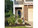 Inviting front entrance with beautiful landscaping and a brick facade at 201 Jonquil Spring Rd, Woodstock, GA 30188