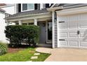 Welcoming front porch with well manicured shrubbery by the entry at 3200 Binghampton Ln, Lawrenceville, GA 30044