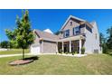 Lovely two-story brick home featuring manicured landscaping and an attached two-car garage at 5440 Wheeler Ridge Rd, Auburn, GA 30011