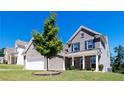 Beautiful two-story brick home with a landscaped yard and a spacious two-car garage at 5440 Wheeler Ridge Rd, Auburn, GA 30011