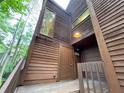 Inviting entrance featuring wood facade, a large window, and a light fixture above the front door at 2449 Terrace Trl, Decatur, GA 30035
