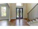 Elegant entryway featuring decorative double doors and hardwood floors at 3065 Reserve Ct Sw, Conyers, GA 30094