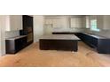 Spacious kitchen with dark wood cabinets, granite counters, and a large center island at 3292 Mill Forest Dr, Conyers, GA 30094