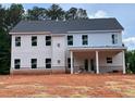 Two-story home with white siding, multiple windows, and a covered back porch at 3292 Mill Forest Dr, Conyers, GA 30094