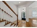 Elegant foyer featuring hardwood floors, staircase with wooden banister and entrance with sidelights at 661 Lockton Pl, Sandy Springs, GA 30342