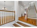 Bright foyer with hardwood floors, stairs, and chandelier adds elegance to this home at 661 Lockton Pl, Sandy Springs, GA 30342