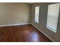 Bright bedroom with two windows, neutral walls, and beautiful dark wood-look floors at 6536 Rebecca Lou Ln, Lithonia, GA 30058
