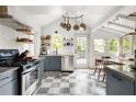 Bright kitchen with stainless steel appliances, white subway tile backsplash, and checkered floors at 1682 Grace Se St, Atlanta, GA 30316