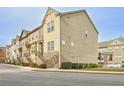 Charming multi-level townhome features a stone and vinyl facade with inviting staircase at 204 Mahnaz Dr, Atlanta, GA 30331