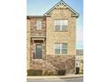 Charming multi-level townhome features a stone and brick facade with inviting staircase at 204 Mahnaz Dr, Atlanta, GA 30331
