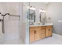 Modern bathroom showcasing a glass shower, herringbone tile, and light wood double vanity at 4530 Upland Court, Cumming, GA 30040