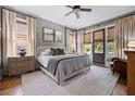 Comfortable bedroom features neutral walls, plush carpet, and doors that open to the outside at 4530 Upland Court, Cumming, GA 30040