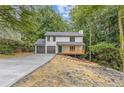 Charming two-story home featuring a welcoming porch, a two-car garage, and landscaping to be completed at 2599 Willow Creek Dr, Duluth, GA 30096