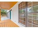 Inviting front porch with wood floors and white siding, complemented by large windows and a bright blue front door at 2599 Willow Creek Dr, Duluth, GA 30096