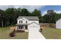 Charming two-story home with manicured lawn and a two car garage at 272 Broadstone Blvd, Acworth, GA 30101