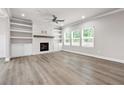 Spacious living room features a fireplace, hardwood floors, and built-in shelves at 272 Broadstone Blvd, Acworth, GA 30101