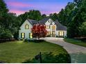 Stunning two-story home with lush landscaping, a circular drive, and a beautifully maintained lawn at 414 Dogwood Way, Canton, GA 30114