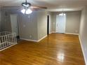 Open-concept living room area with hardwood floors and white front door at 6956 Kimberland Gardens Ln, Lithonia, GA 30058