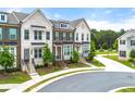 Street view showcasing townhomes with brick and sidewalks in a well-maintained neighborhood at 1172 Edwin Ln, Sugar Hill, GA 30518
