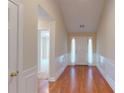 Bright hallway with light cream colored walls, white trim, and gleaming hardwood floors at 2010 Hickory Station Cir, Snellville, GA 30078
