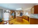 Bright kitchen features wood cabinets, stainless steel appliances, and an island with wood floors at 2010 Hickory Station Cir, Snellville, GA 30078