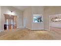 Spacious living room featuring neutral carpet and an open layout leading to other rooms at 2010 Hickory Station Cir, Snellville, GA 30078