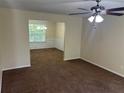 Open living area featuring neutral walls and an adjacent dining space, great for entertaining at 3827 Micah Ln, Ellenwood, GA 30294