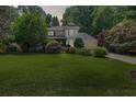Charming two-story home at twilight with a well-manicured lawn and lush landscaping at 3231 Connemara Trce, Lawrenceville, GA 30044