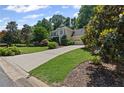 Charming two-story home with a long driveway, well-manicured lawn and lush landscaping at 3231 Connemara Trce, Lawrenceville, GA 30044
