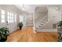 Inviting foyer with hardwood floors, staircase, and ample natural light at 3894 Land O Lakes Ne Dr, Atlanta, GA 30342
