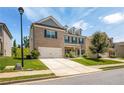 Beautiful two-story home showcasing a brick facade, attached two-car garage, and green lawn at 18 Dorothy Ln, Lawrenceville, GA 30046