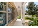 Inviting front porch with brick accents, white pillars, and blooming hydrangea bushes at 18 Dorothy Ln, Lawrenceville, GA 30046