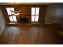 A high-angle view of the living room reveals hardwood floors, stone fireplace, bright windows, and a ceiling fan at 272 Toweridge Dr, Marietta, GA 30064