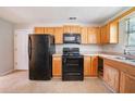 Cozy kitchen with classic wood cabinets, black appliances, and plenty of counter space at 3283 Sugar Creek Falls Se Ave, Atlanta, GA 30316