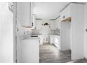 Modern kitchen features white cabinets, sleek countertops, and durable flooring throughout open design at 3845 Springleaf Ct, Stone Mountain, GA 30083