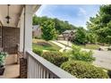 Inviting front porch with white railing, offering serene views of the landscaped front yard at 4371 Wigley Preserve Dr, Marietta, GA 30066