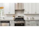 Well-equipped kitchen features stainless steel appliances, subway tile backsplash, and granite countertops at 936 Ormewood Se Ter, Atlanta, GA 30316