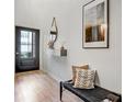 Bright entryway with wood floors, a modern bench, and stylish decor at 1233 Miss Irene Ln, Lawrenceville, GA 30044