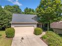 Exterior view of a well-maintained home, featuring a two-car garage and lush landscaping at 139 Mountain Vista Blvd, Canton, GA 30115