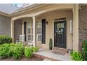 Charming front porch featuring rocking chairs, complemented by well-maintained landscaping at 139 Mountain Vista Blvd, Canton, GA 30115