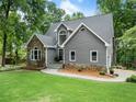 Well-maintained home with stone veneer and siding, set on a lush green lawn at 1920 Pilgrim Rd, Cumming, GA 30040