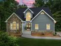 Beautiful home with stone and siding exterior, enhanced by professional outdoor lighting at 1920 Pilgrim Rd, Cumming, GA 30040