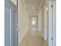 Inviting hallway featuring light wood flooring and ample natural light creating a welcoming atmosphere at 2525 Dixon Pl, Lawrenceville, GA 30045