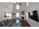 Bright living room with tall ceilings, fireplace, hardwood floors, and large windows at 5465 Mountain Top Pl, Cumming, GA 30041