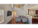 Spacious living room with an open floor plan, high ceilings, hardwood floors, and staircase at 5465 Mountain Top Pl, Cumming, GA 30041