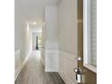 Inviting entryway featuring gray wood-look flooring, white wainscoting, and natural light at 1360 Sugar Glen Ct, Lawrenceville, GA 30044