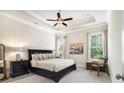 Spacious main bedroom with tray ceilings, plush carpet, and ample natural light at 11375 Crestview Ter, Johns Creek, GA 30024