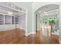 Elegant interior showcasing hardwood floors, archways, and custom built-in shelving at 2301 Kirk Farm Nw Pl, Kennesaw, GA 30152