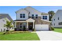 Charming two-story home featuring a stone facade, white siding, and an attached two-car garage at 4011 Fallen Leaf Ct, Kennesaw, GA 30152
